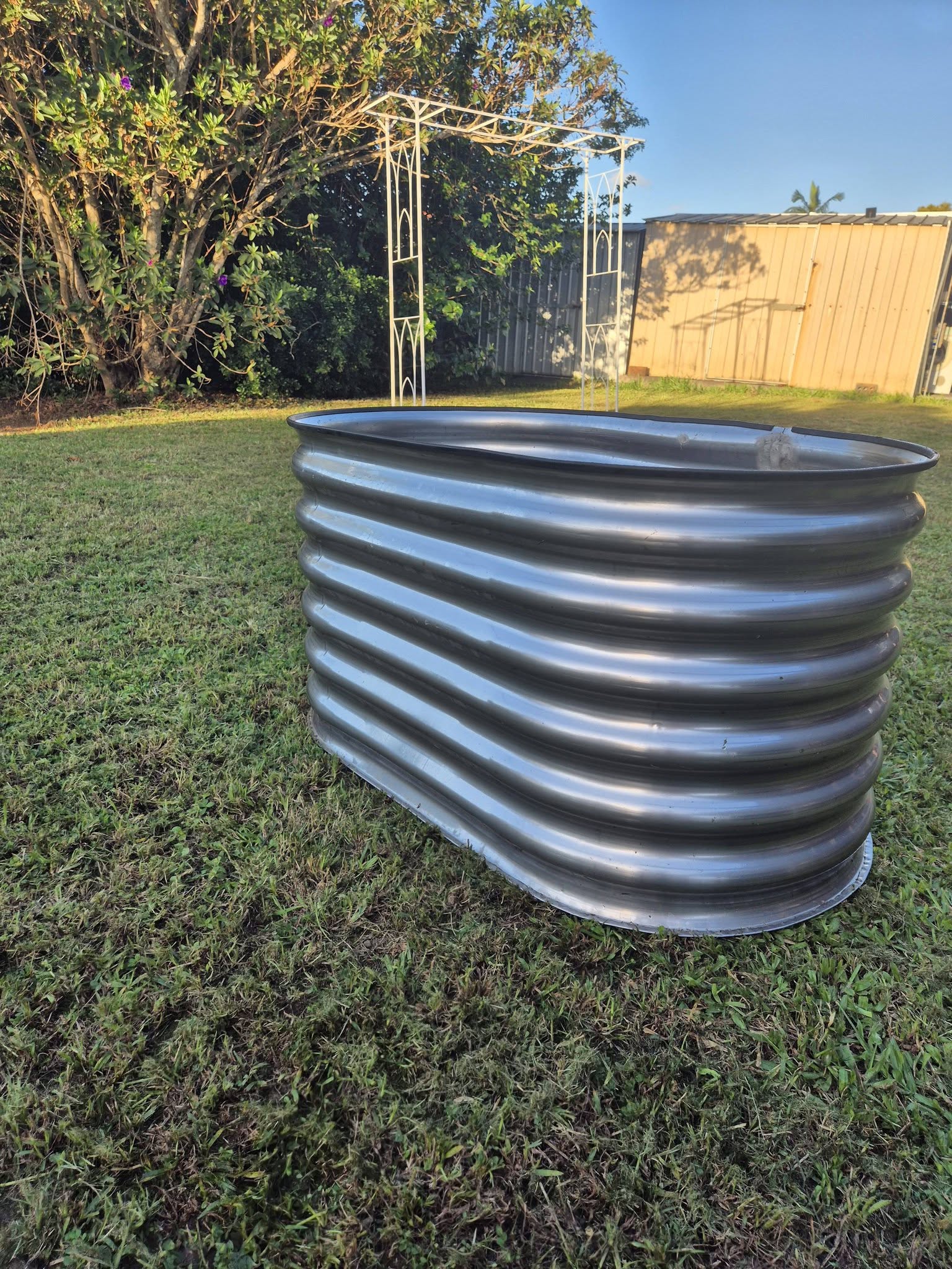 Stainless steel raised garden bed — low angle showing base and pinch weld