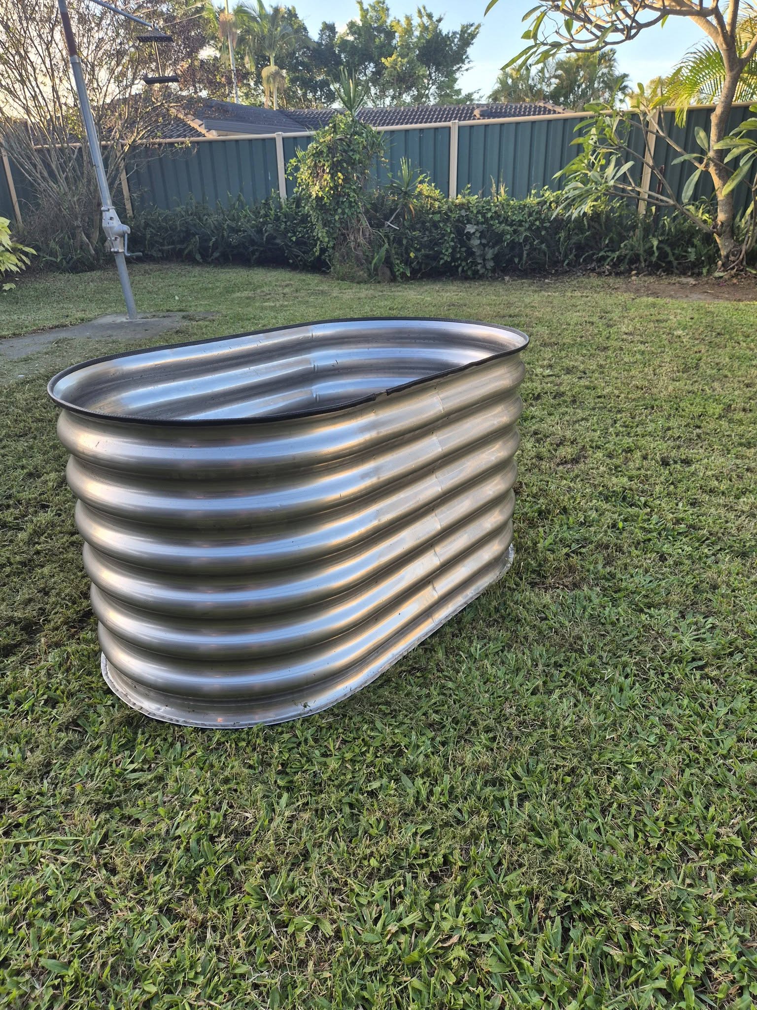 Stainless steel raised garden bed — side view in garden setting